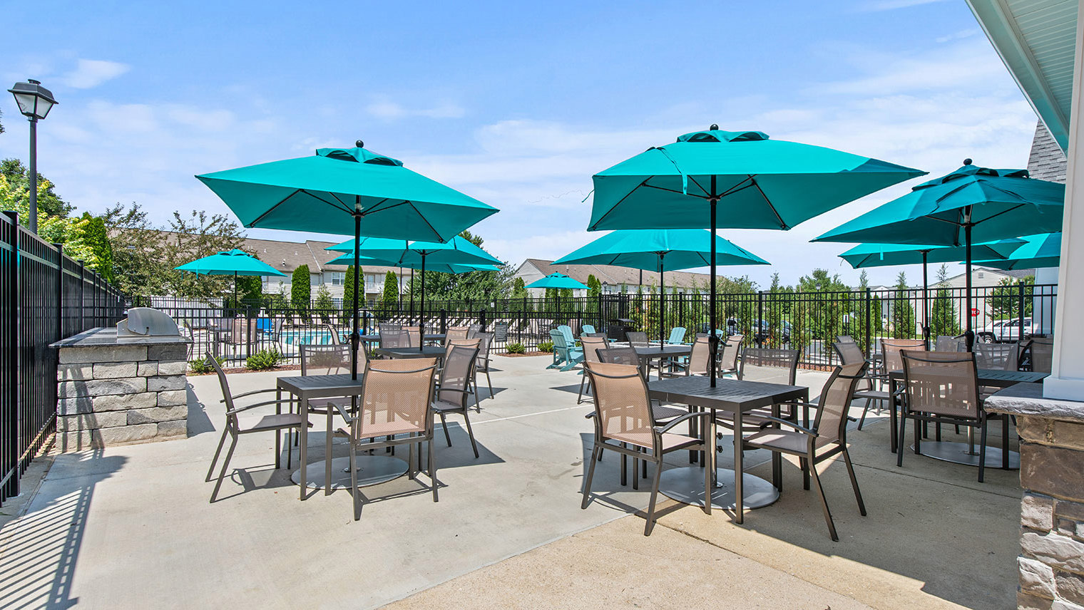The View at Mackenzi Garden apartments with outdoor pool and lounge seating in York, PA – The View at Mackenzi