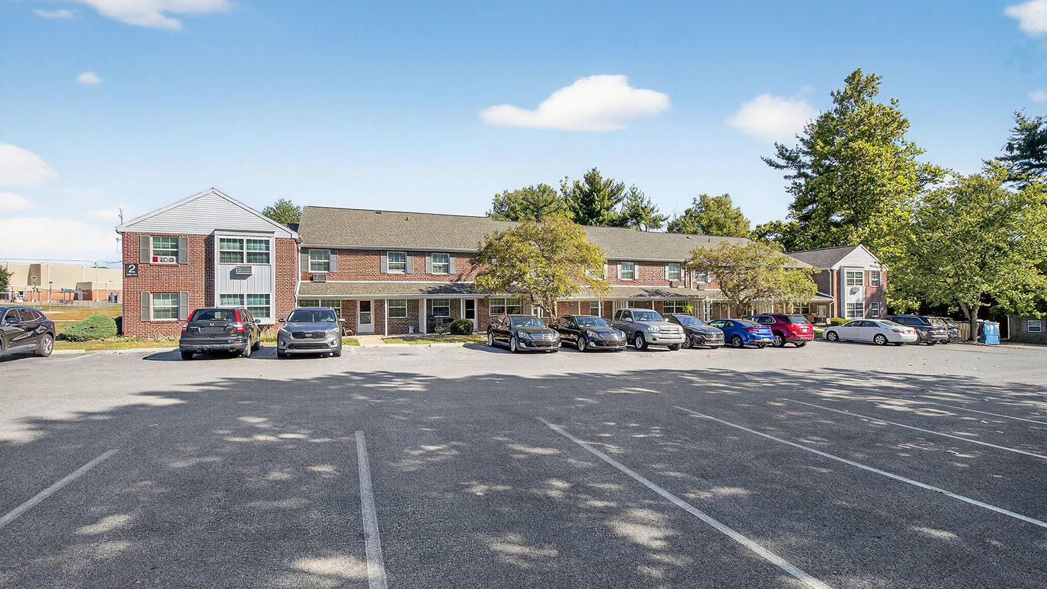 The Reserve at Copper Chase residential building exterior with parking - The Reserve at Copper Chase in York, PA