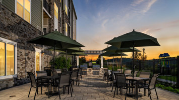 Monte View at Pohatcong Twilight view of luxury apartment rentals with an outdoor grill station in Pohatcong, NJ – Monte View at Pohatcong