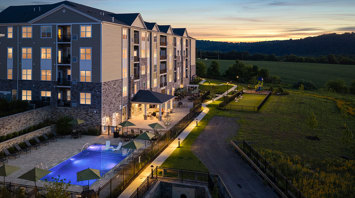 Monte View at Pohatcong Twilight view of pool, pavilion, tot lot, and bark park at luxury apartment community in Pohatcong, NJ – Monte View at Pohatcong