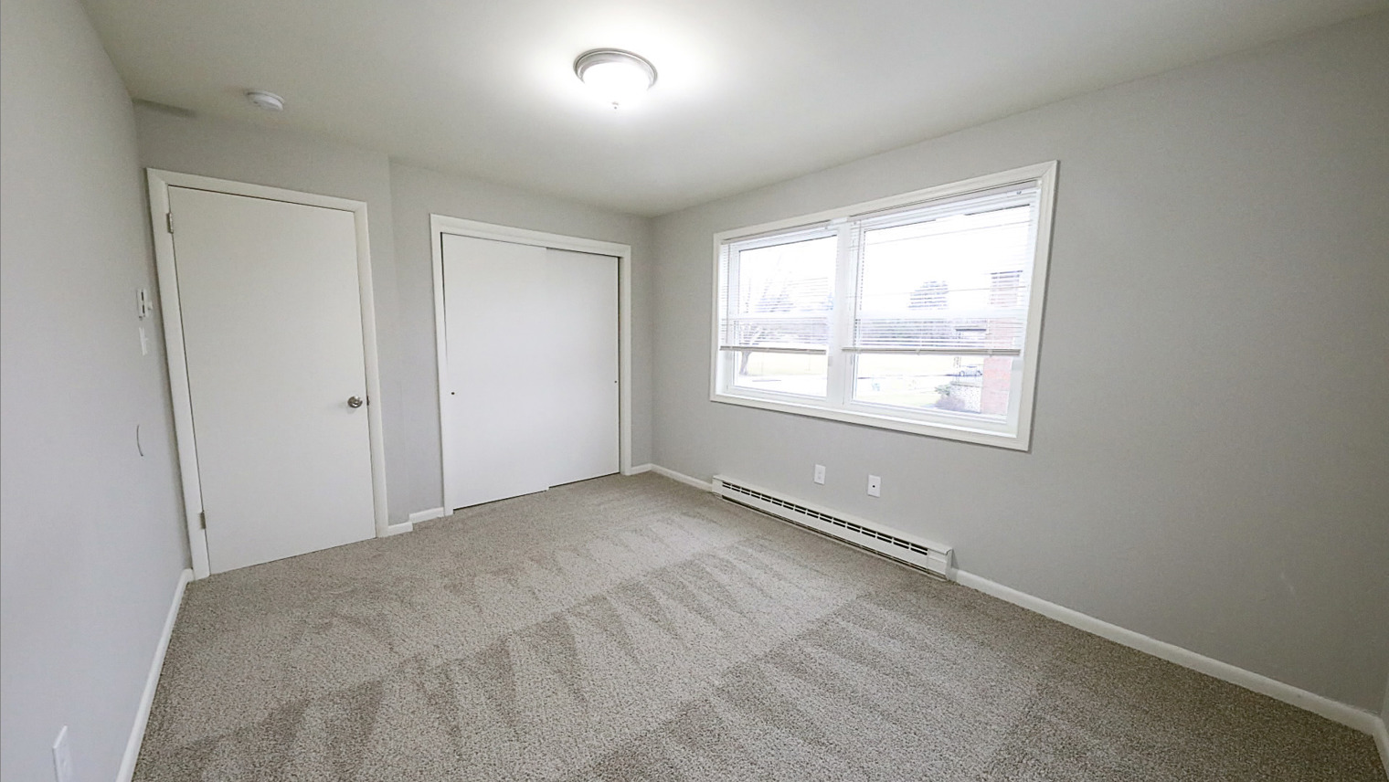 Geraldine Street Apartments Affordable pet-friendly apartment rental primary bedroom with windows and closet in Bethlehem, PA – Geraldine Street Apartments