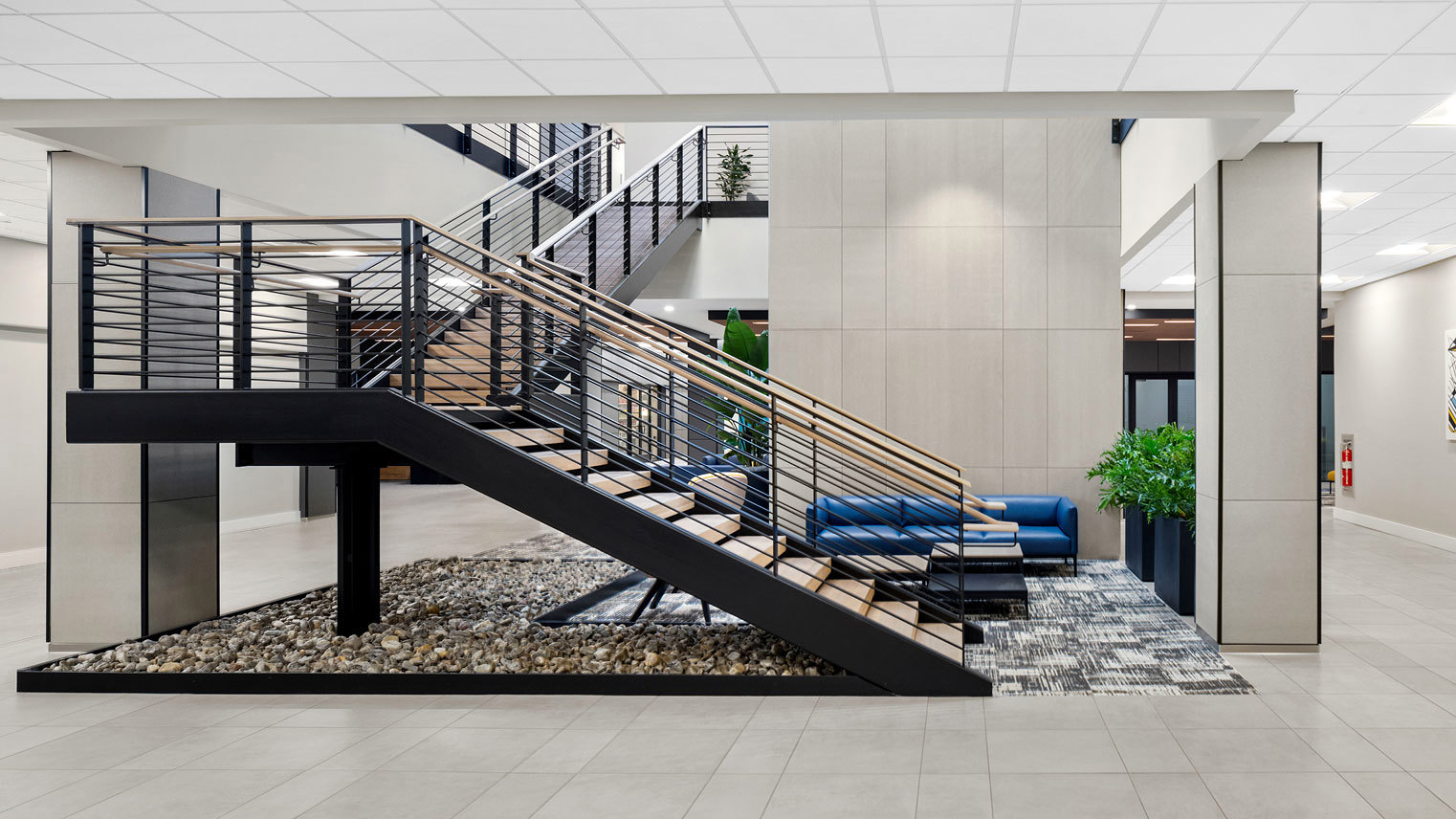 3 West Contemporary lobby featuring an open staircase and modern seating in two-story building offering built-to-suit retail and office space for rent in Downtown Bethlehem, PA – 3 West