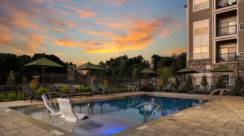 Monte View at Pohatcong Twilight view of outdoor pool with tanning ledge at luxury apartment community in Pohatcong, NJ – Monte View at Pohatcong