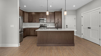 Monte View at Pohatcong Luxury elevator building apartment kitchen with an island, quartz countertops, and stainless steel appliances in Pohatcong Twp, NJ – Monte View at Pohatcong