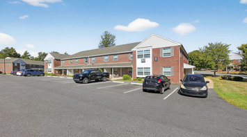The Reserve at Copper Chase residential building exterior with parking - The Reserve at Copper Chase apartments and townhomes for rent in York, PA