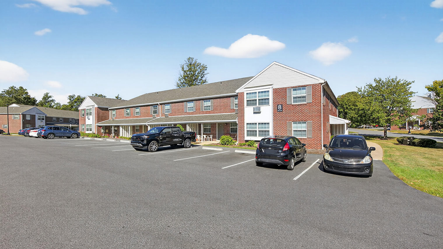 The Reserve at Copper Chase residential building exterior with parking - The Reserve at Copper Chase apartments and townhomes for rent in York, PA